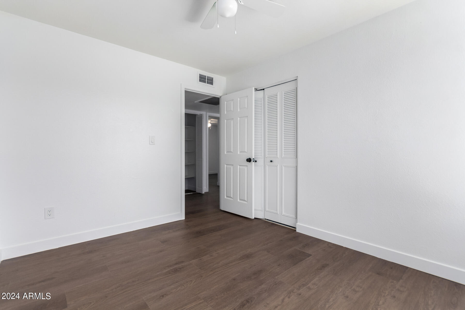 5338 West Coronado Road Phoenix, AZ 85035 - Photo 16 of 29 a view of an empty room with wooden floor