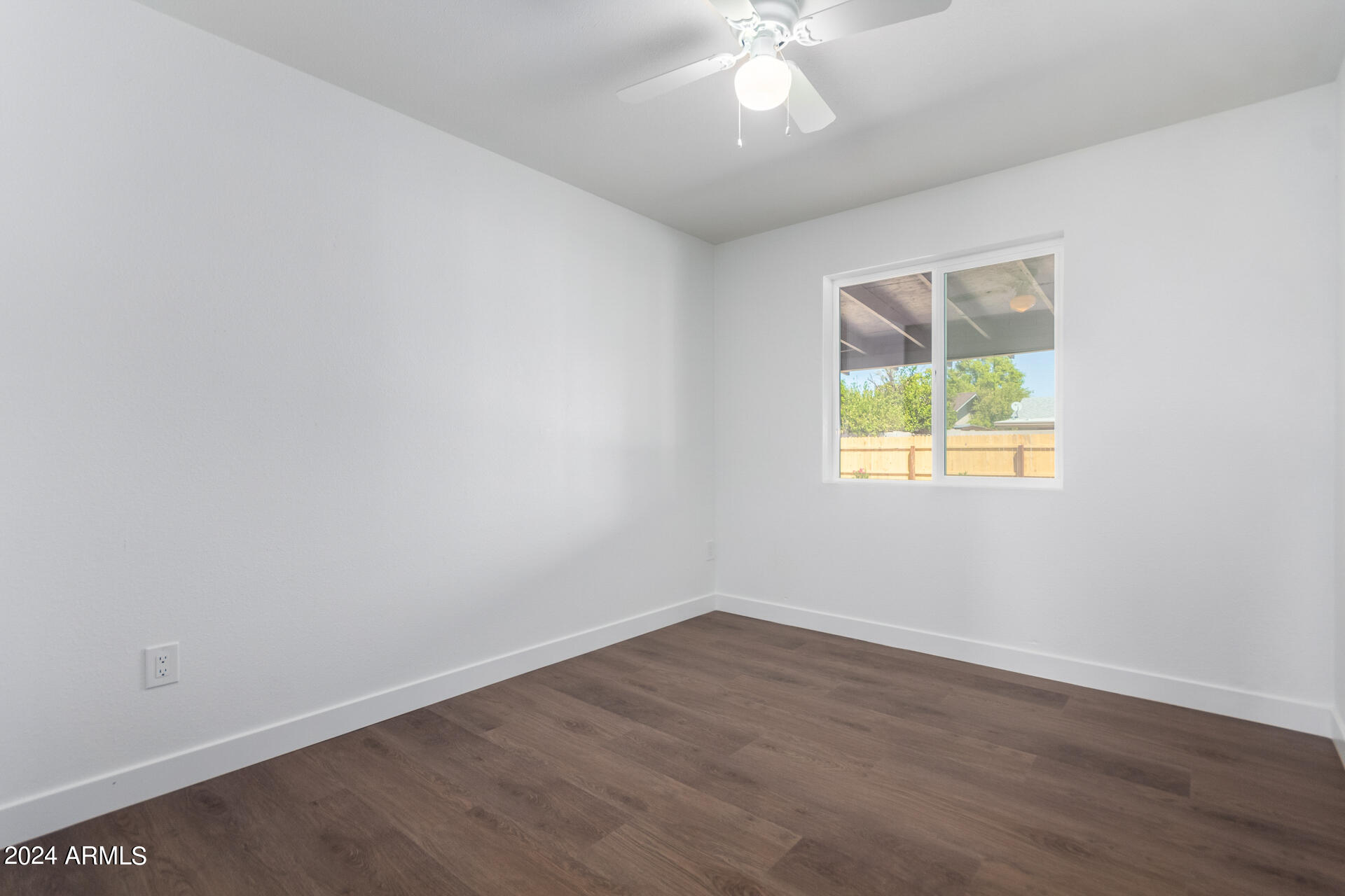 5338 West Coronado Road Phoenix, AZ 85035 - Photo 17 of 29 an empty room with wooden floor and windows