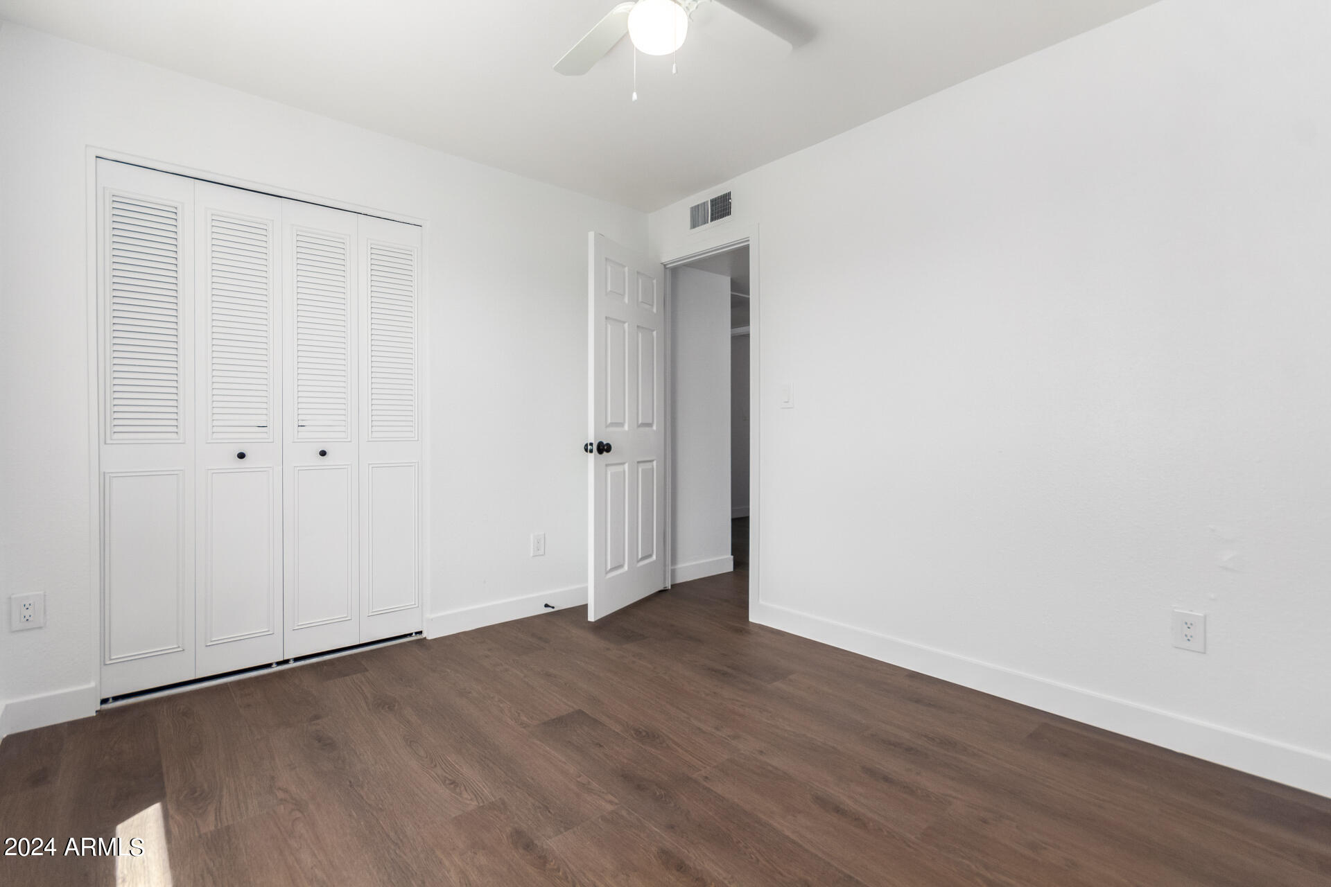 5338 West Coronado Road Phoenix, AZ 85035 - Photo 20 of 29 a view of an empty room with wooden floor
