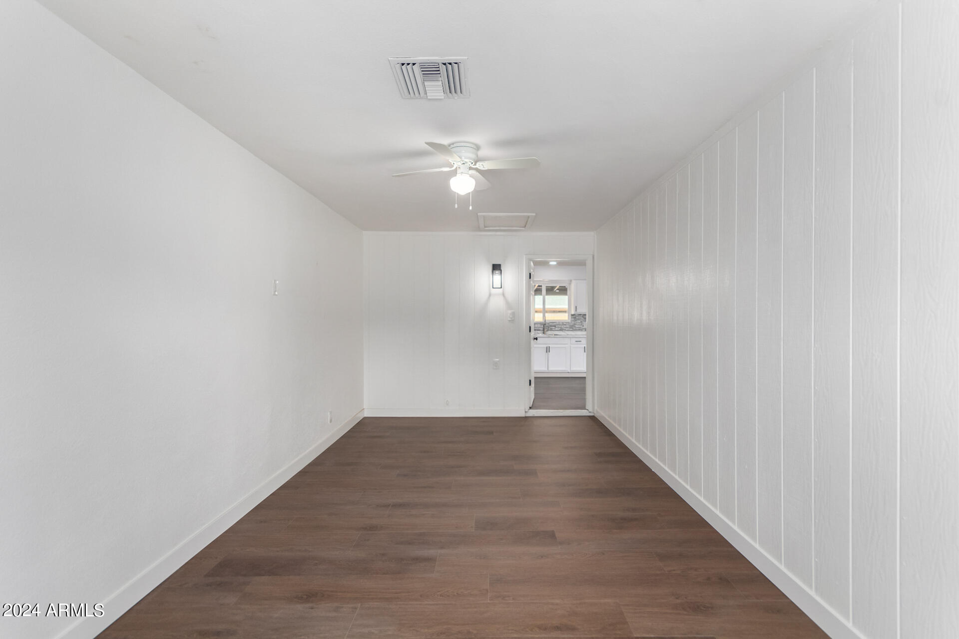 5338 West Coronado Road Phoenix, AZ 85035 - Photo 21 of 29 a view of a hallway with wooden floor and a chandelier fan