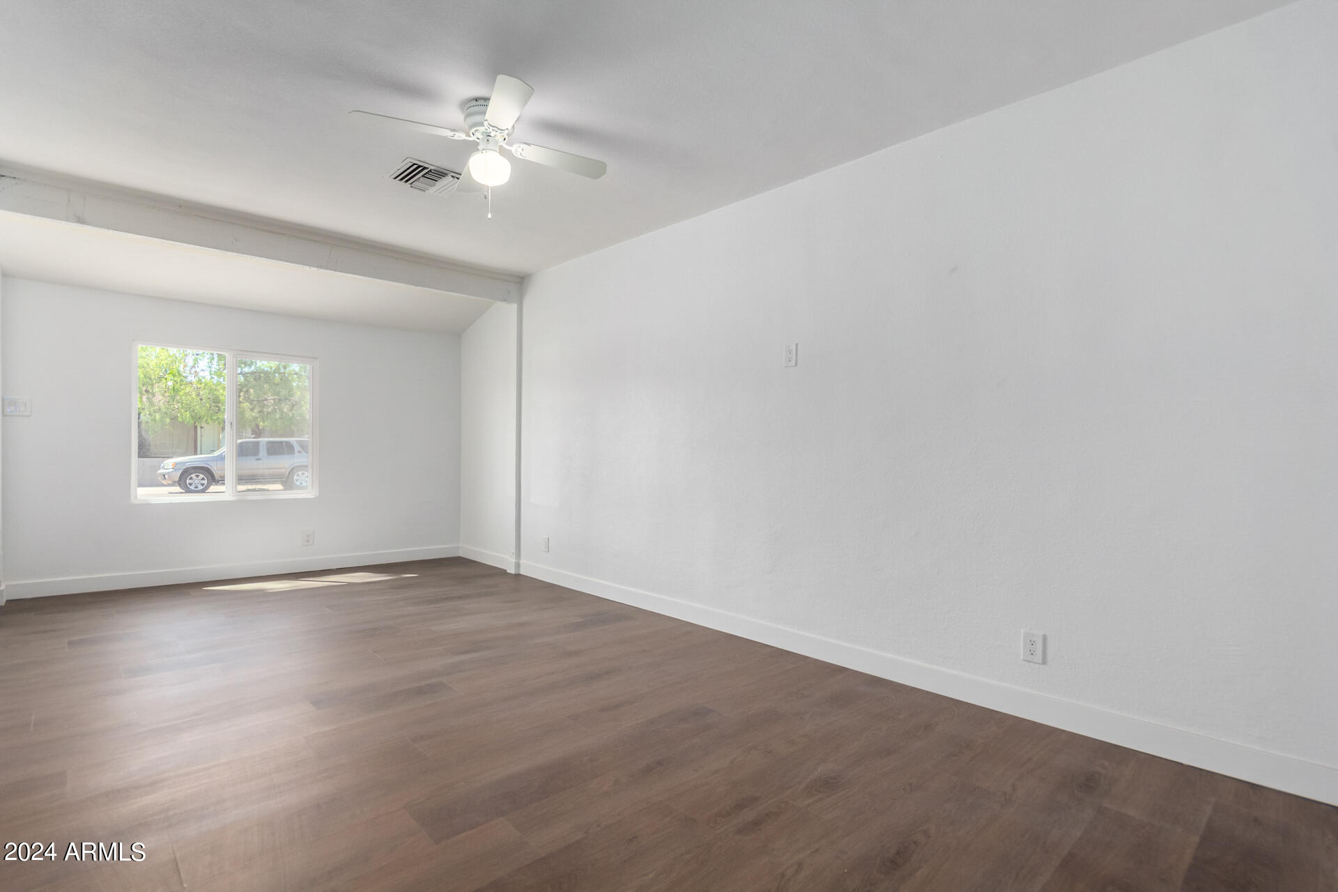 5338 West Coronado Road Phoenix, AZ 85035 - Photo 22 of 29 an empty room with wooden floor and windows