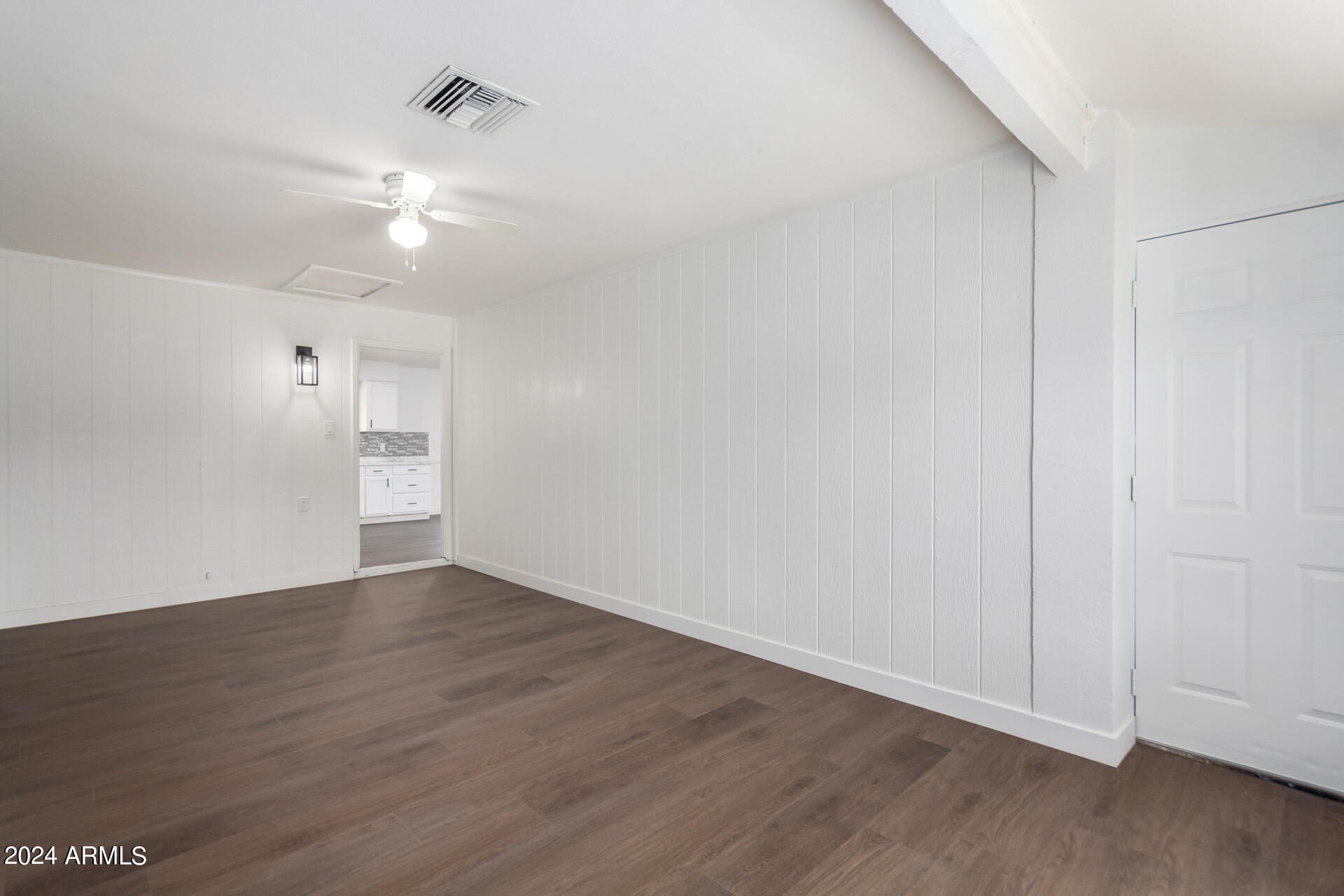 5338 West Coronado Road Phoenix, AZ 85035 - Photo 23 of 29 an empty room with wooden floor and ceiling fan
