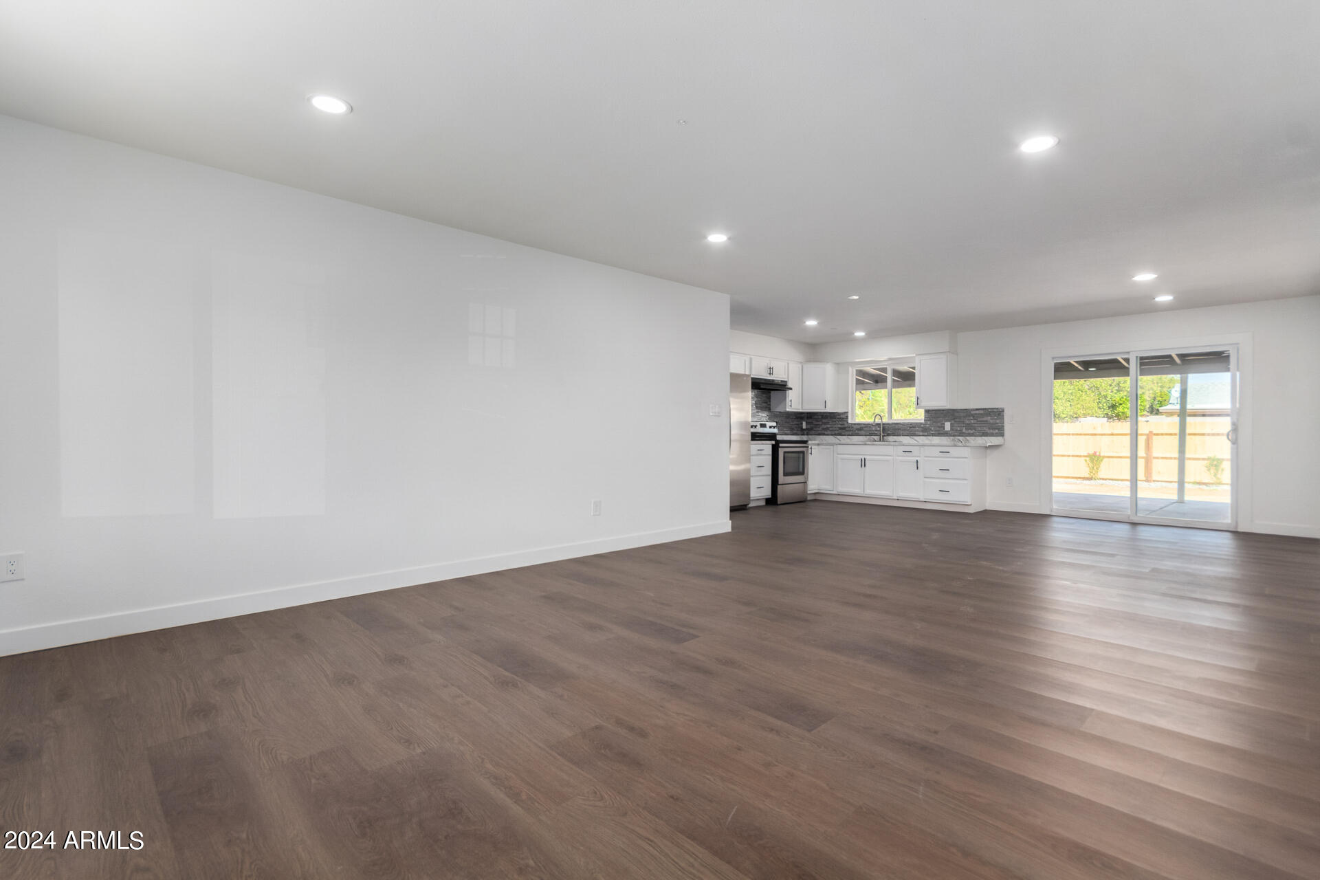 5338 West Coronado Road Phoenix, AZ 85035 - Photo 6 of 29 an empty room with wooden floor and windows
