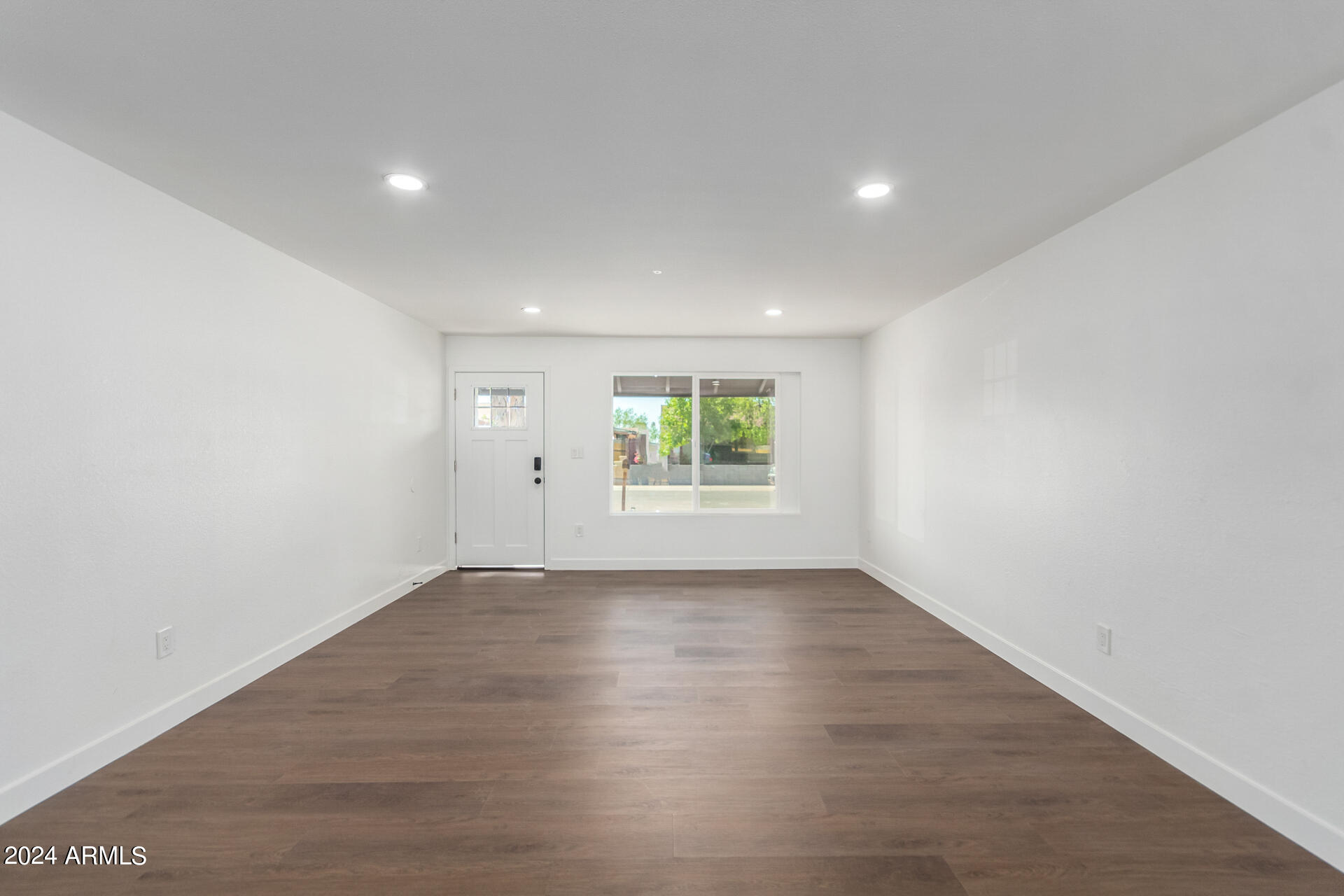 5338 West Coronado Road Phoenix, AZ 85035 - Photo 7 of 29 an empty room with wooden floor and windows