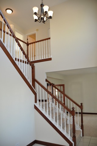2205 Clipper Court Elgin, IL 60123 - Photo 4 of 24 a view of staircase with railing and a chandelier