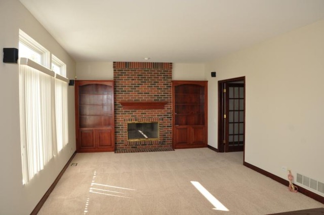 2205 Clipper Court Elgin, IL 60123 - Photo 6 of 24 a view of an empty room with a fireplace and a window