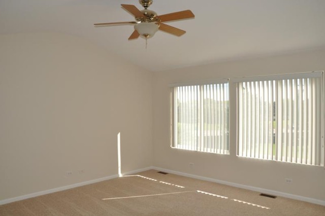 2205 Clipper Court Elgin, IL 60123 - Photo 10 of 24 an empty room with windows and fan