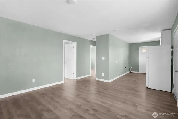 a view of an empty room with wooden floor