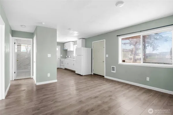 wooden floor in an empty room with a window