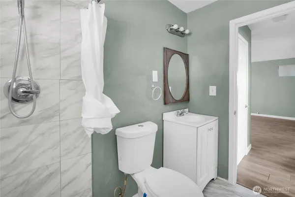 a white toilet sitting next to a bathroom sink