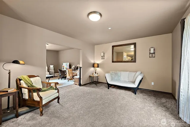 a living room with furniture and a lamp