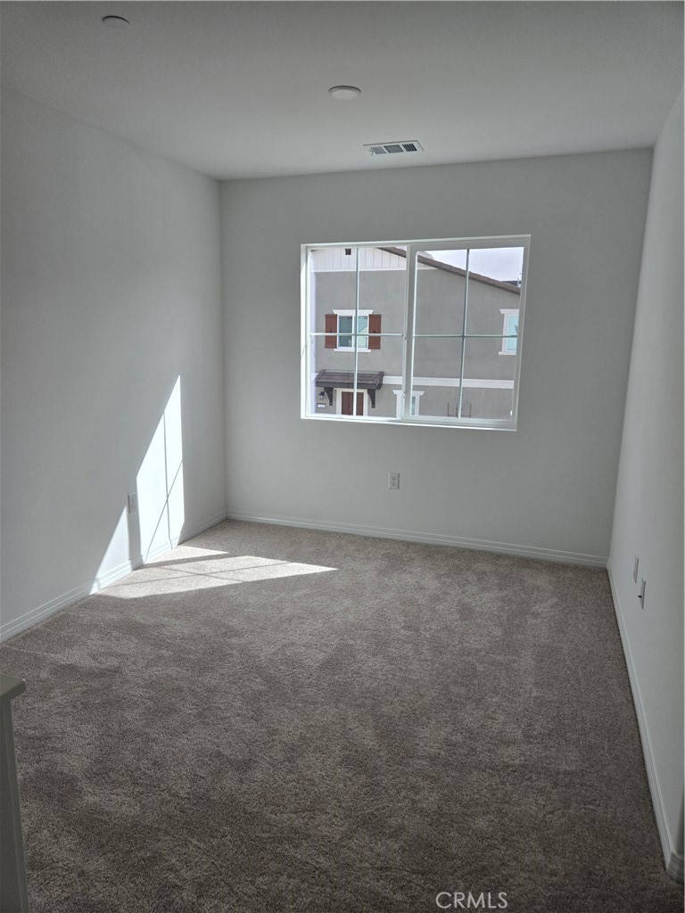 7281 Olive Grv Street Riverside, CA 92507 - Photo 11 of 27 an empty room with a fireplace