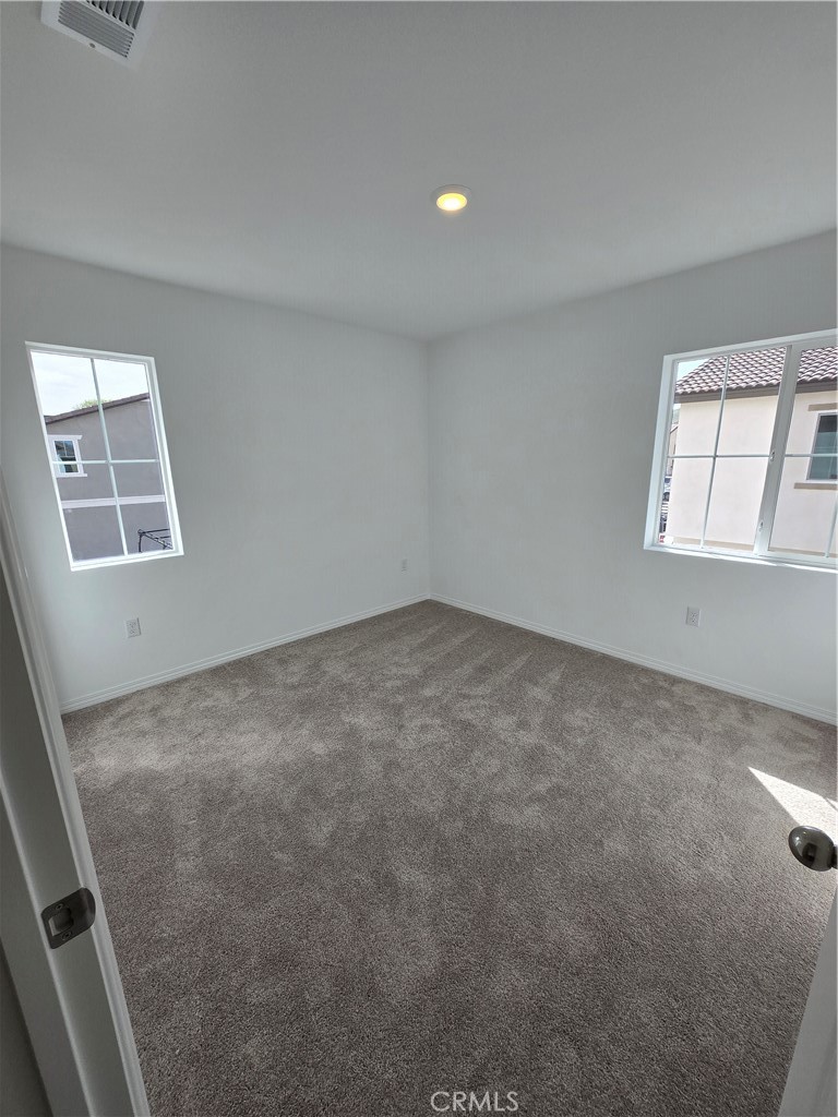 7281 Olive Grv Street Riverside, CA 92507 - Photo 12 of 27 an empty room with windows