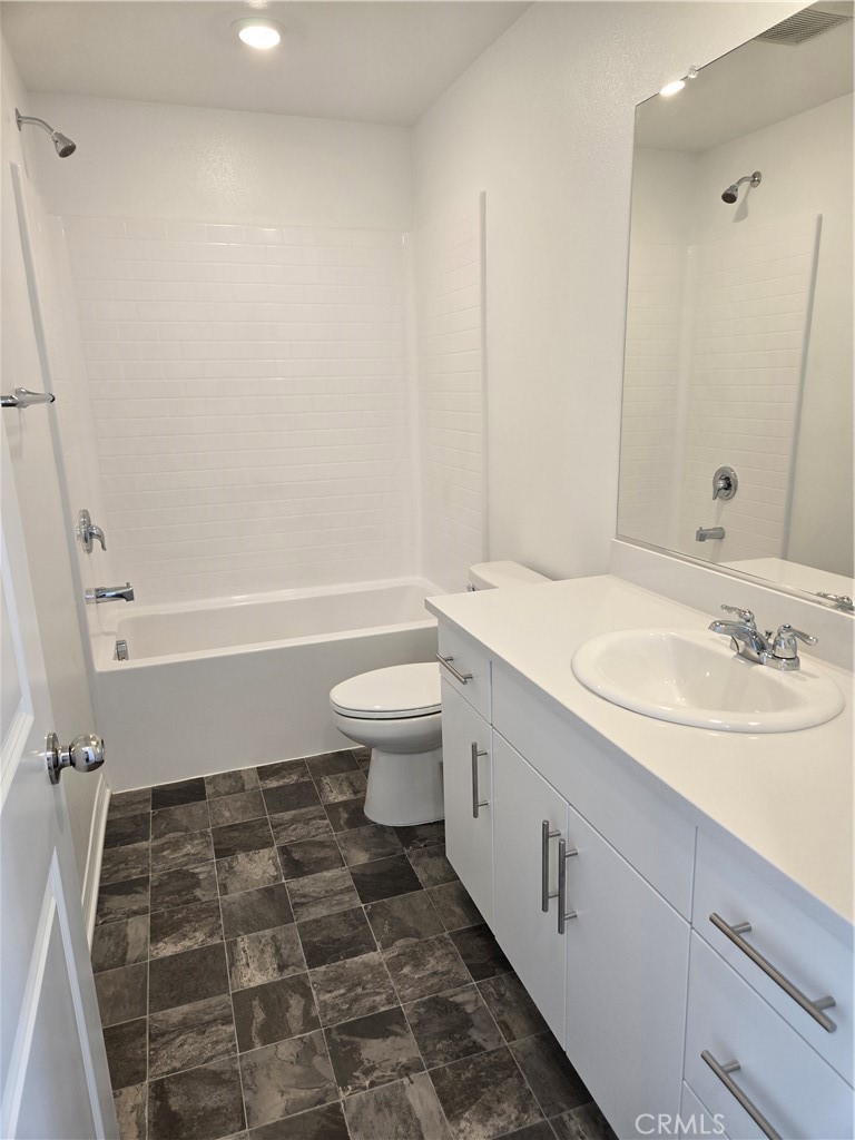 7281 Olive Grv Street Riverside, CA 92507 - Photo 15 of 27 a bathroom with a sink a toilet and shower
