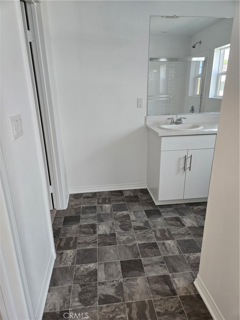 7281 Olive Grv Street Riverside, CA 92507 - Photo 18 of 27 a bathroom with a sink and a mirror