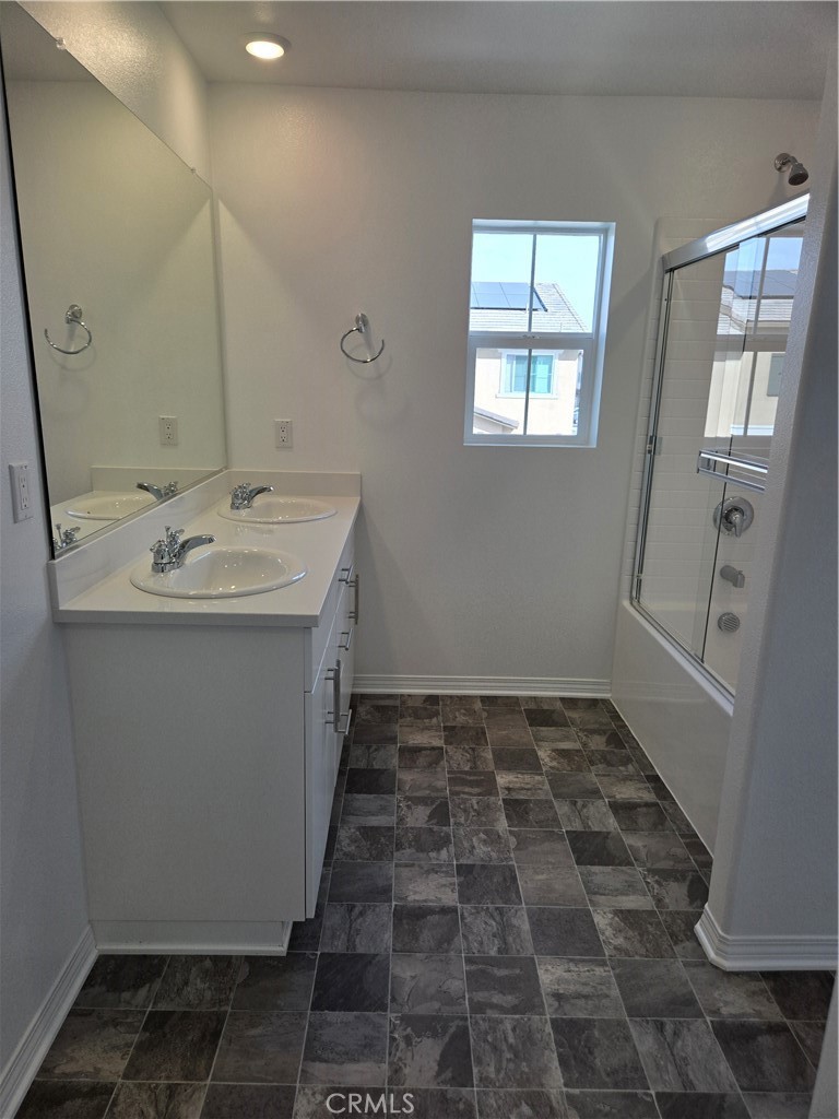7281 Olive Grv Street Riverside, CA 92507 - Photo 19 of 27 a bathroom with a sink and a mirror