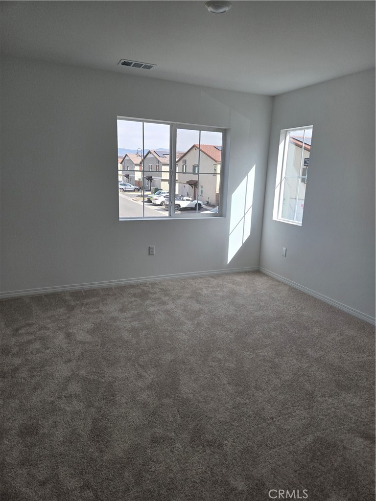 7281 Olive Grv Street Riverside, CA 92507 - Photo 21 of 27 an empty room with windows