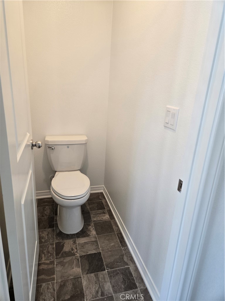 7281 Olive Grv Street Riverside, CA 92507 - Photo 8 of 27 a white toilet sitting next to a shower