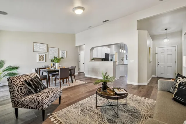 a living room with furniture and wooden floor