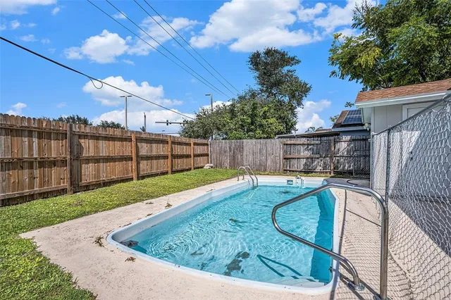 a view of a backyard with a swimming pool