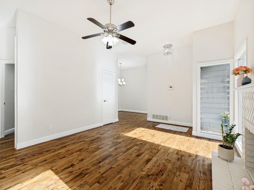 4010 Rive Lane Addison, TX 75001 - Photo 11 of 25 an empty room with wooden floor and chandelier fan