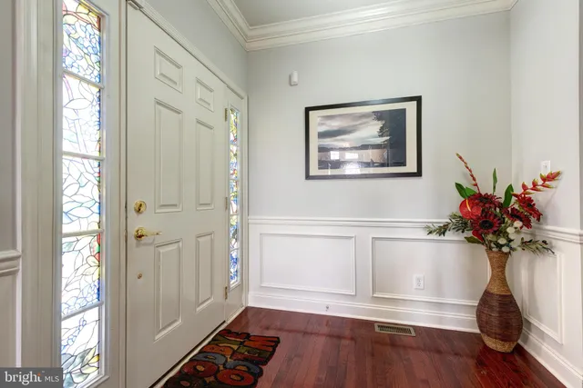 a view of a hallway with wooden floor and a window