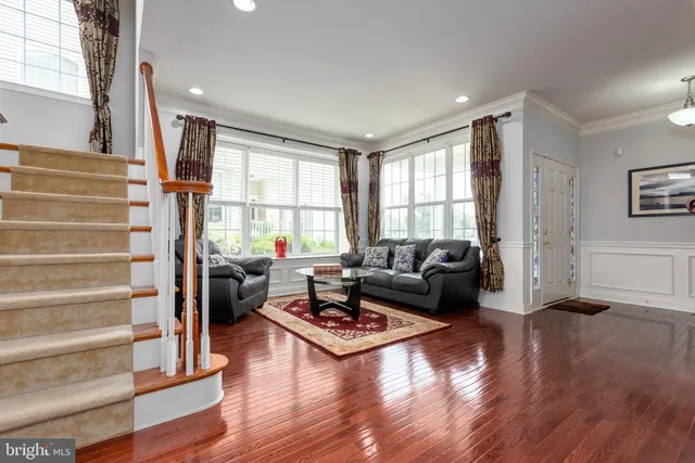 a living room with furniture window and wooden floor