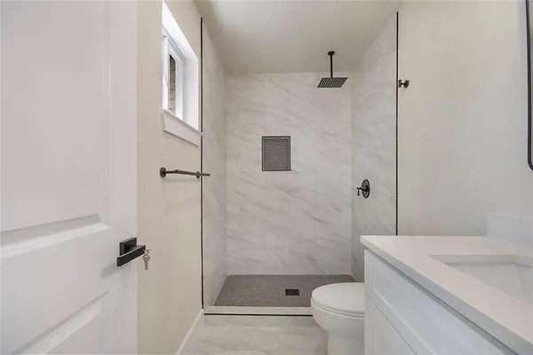 a bathroom with a sink toilet and shower