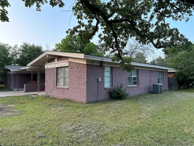 a front view of house with yard and trees