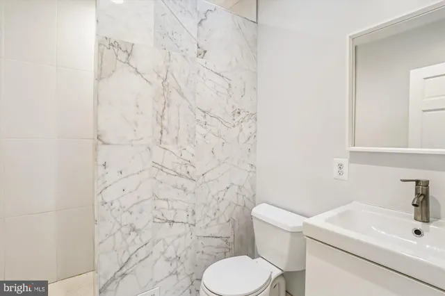 a white house that has tree in front of it