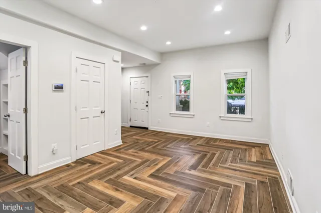 a view of a livingroom with wooden floor and closet
