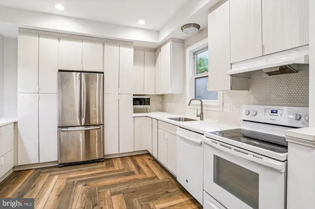 a kitchen with a refrigerator stove and sink