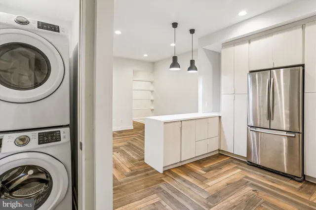 a view of a kitchen with refrigerator and stove