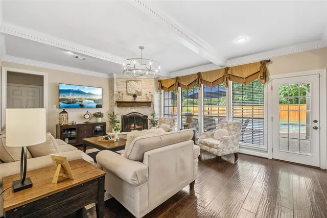 a living room with furniture fireplace and a large window