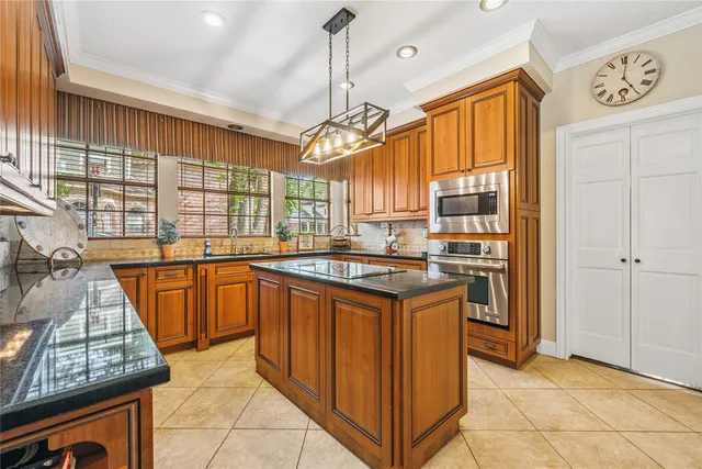 a kitchen with stainless steel appliances granite countertop a stove a sink dishwasher and a refrigerator