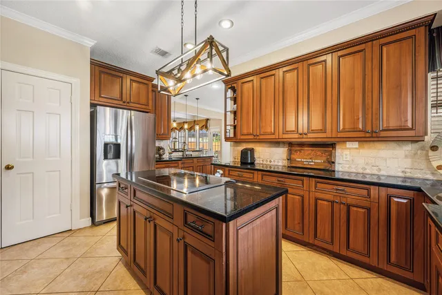an aerial view of a house with a yard and lake view