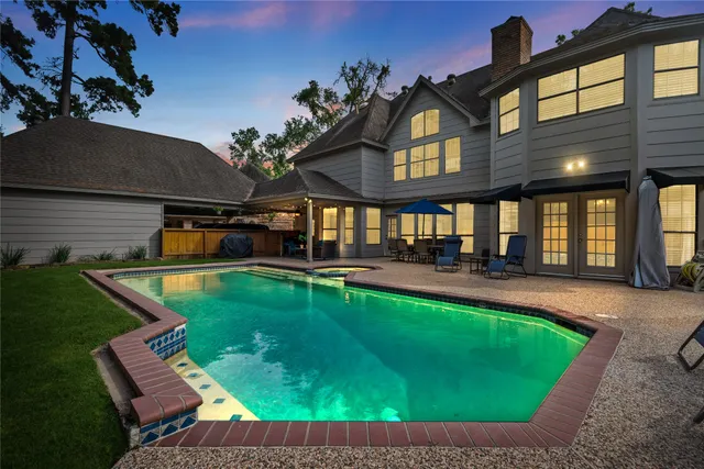 a bathroom with a sink a mirror a window and a shower