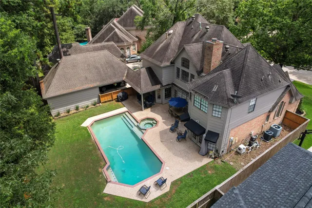an aerial view of a house with a yard