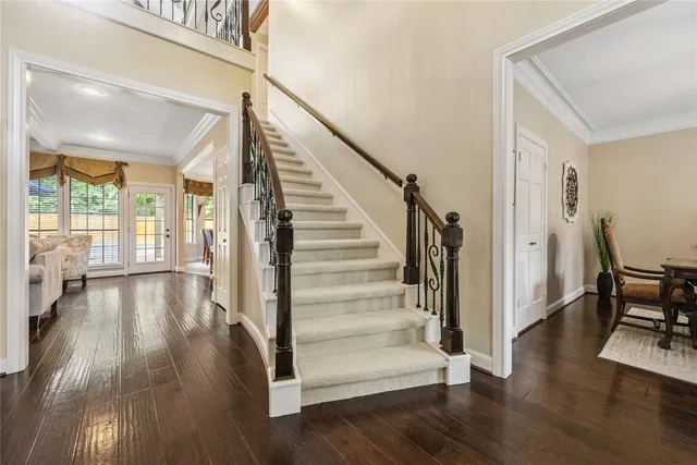 a view of a hallway view with wooden floor and staircase