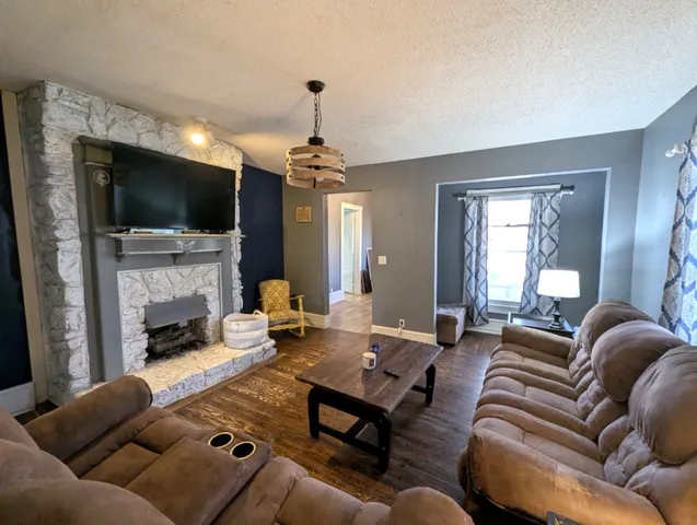 a living room with furniture fireplace and flat screen tv