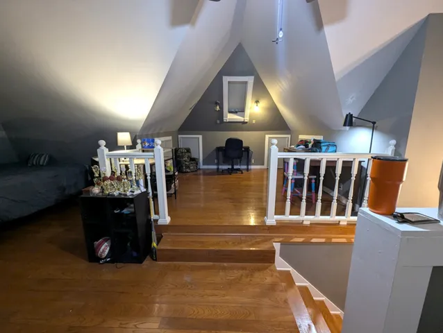 a living room with lots of furniture and stairs