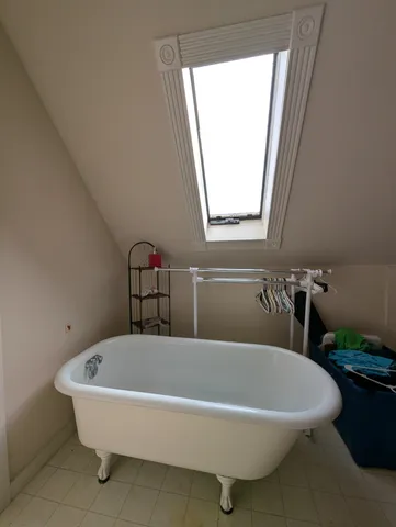 a bathroom with a bathtub and a window
