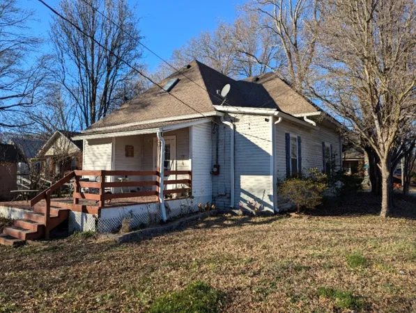 a view of a house with a yard covered in snow