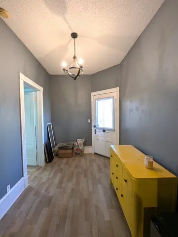 a bedroom with bed and wooden floor
