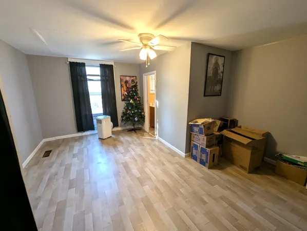 a view of a room with wooden floor and furniture