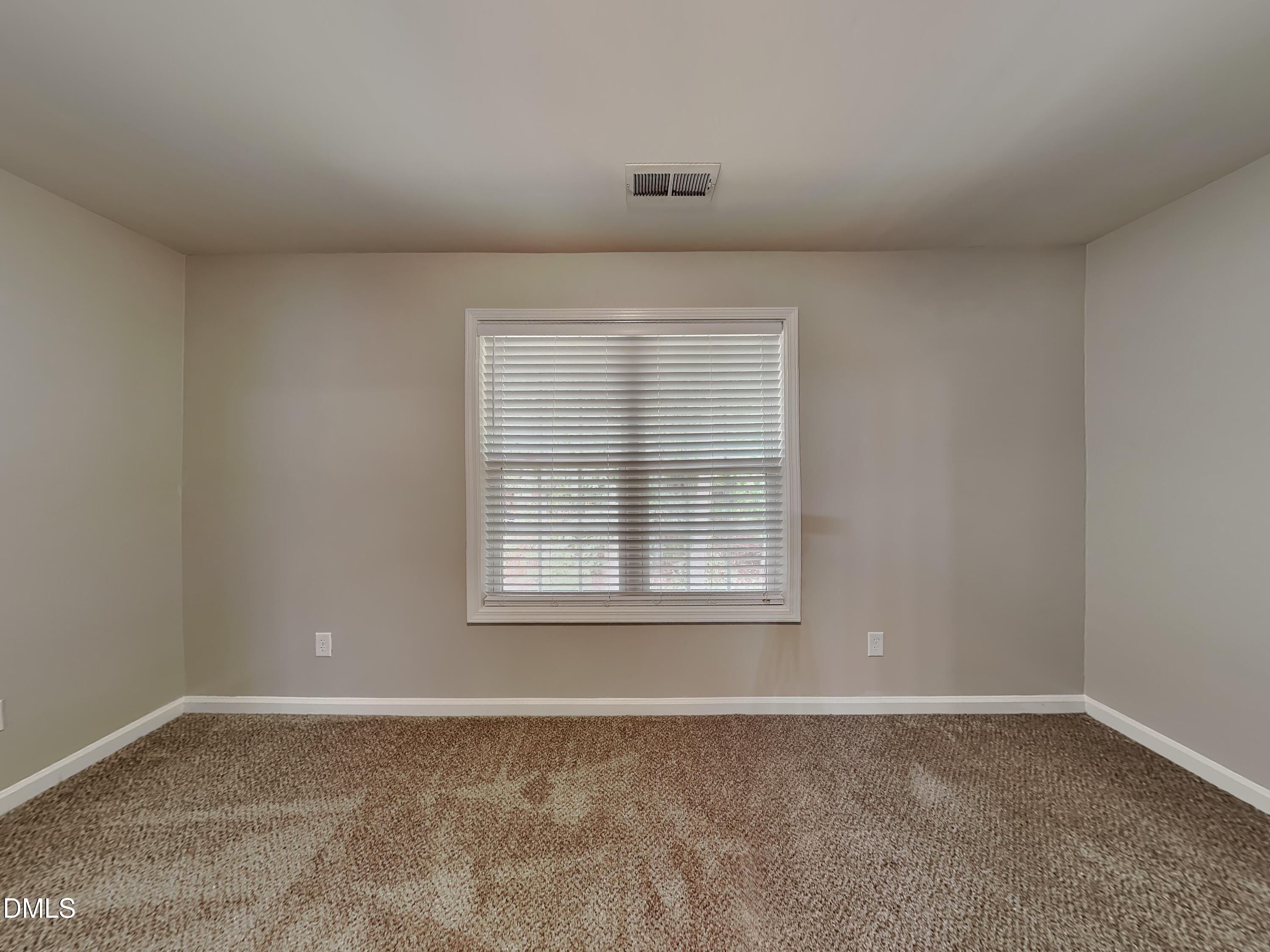 5816 Wynmore Road Raleigh, NC 27610 - Photo 12 of 18 an empty room with a window