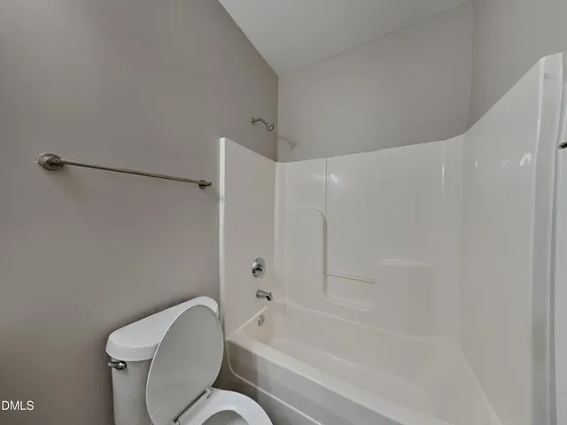 a bathroom with a toilet and a bathtub