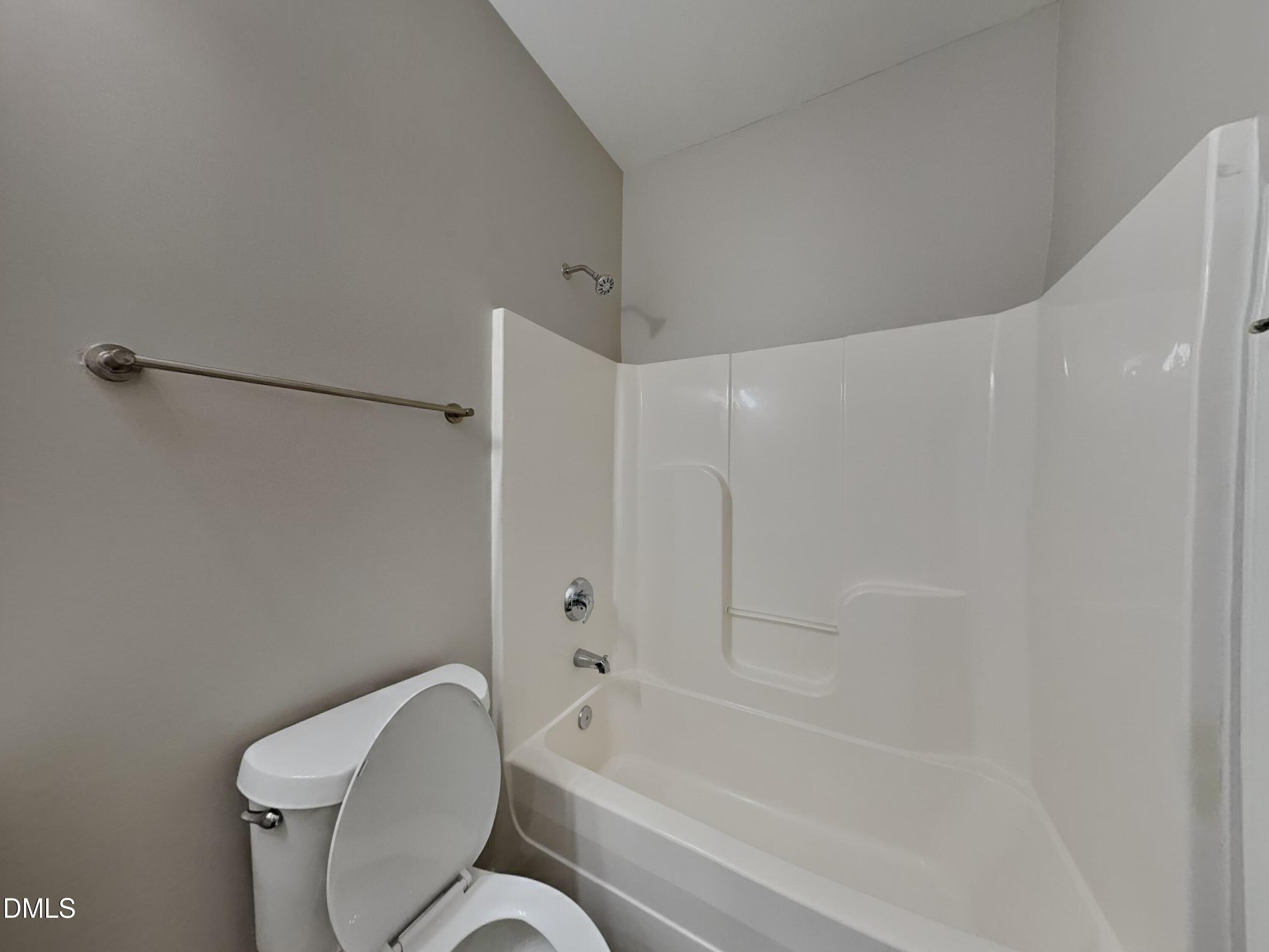 5816 Wynmore Road Raleigh, NC 27610 - Photo 13 of 18 a bathroom with a toilet and a bathtub