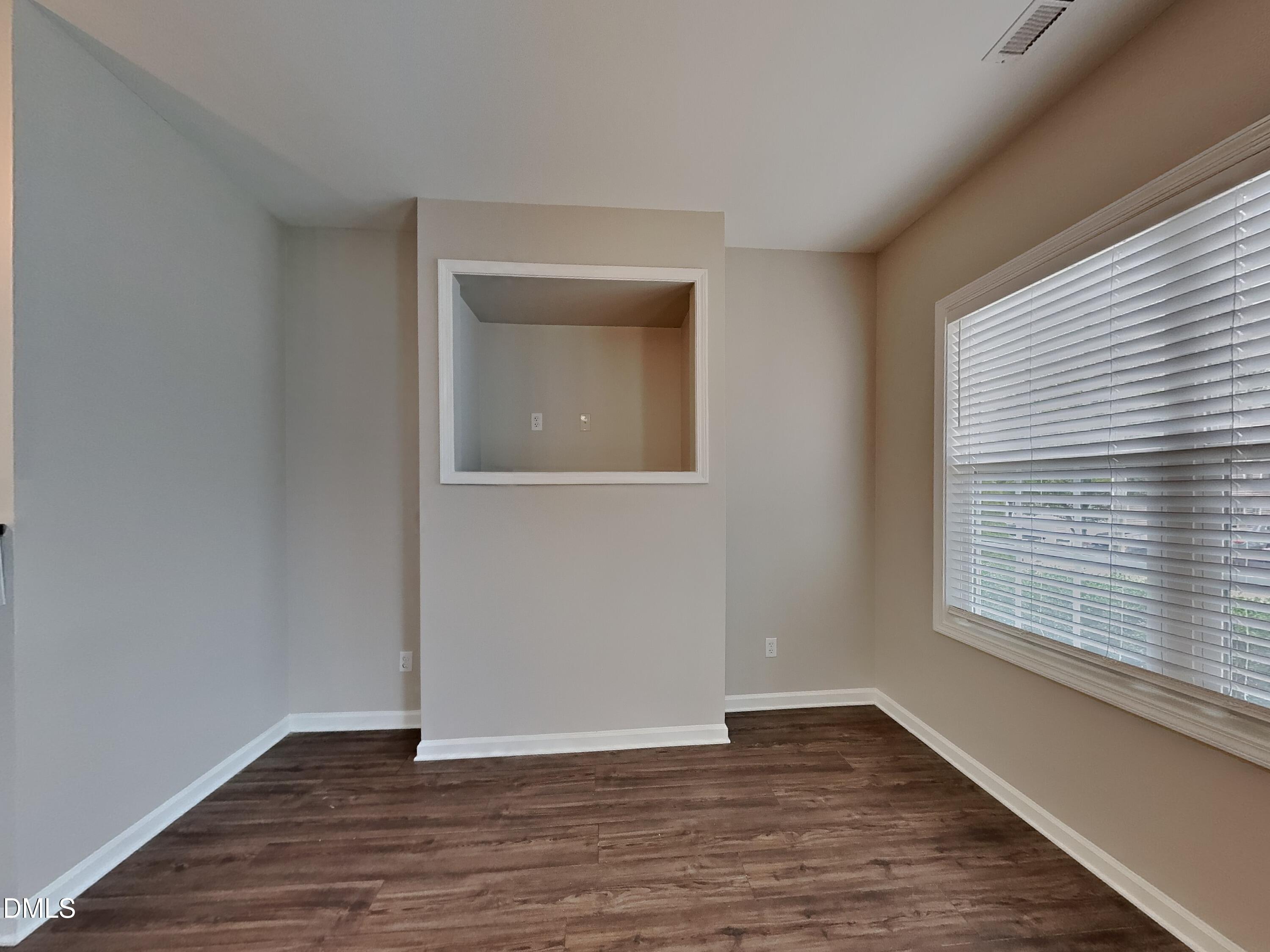 5816 Wynmore Road Raleigh, NC 27610 - Photo 2 of 18 an empty room with wooden floor and windows
