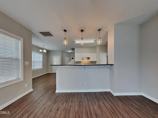 a view of kitchen with wooden floor and windows